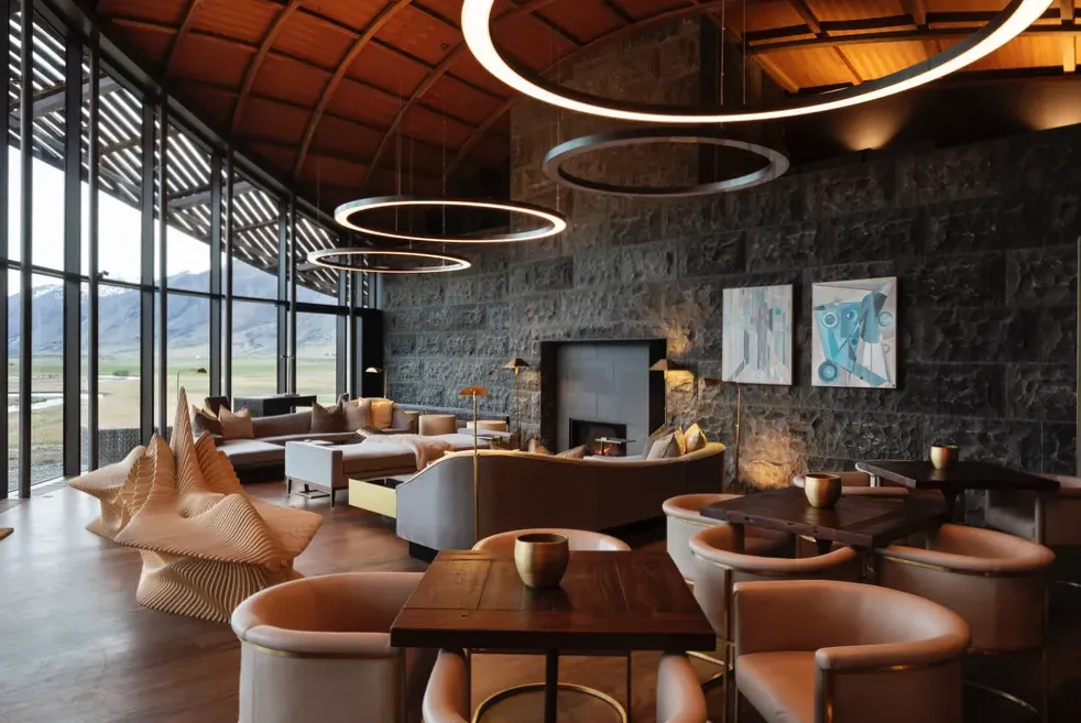 Interior detail of Joyjourney lobby featuring schist stone wall, rimu timber and brass lighting
