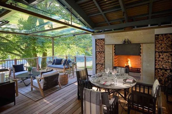 Warm restaurant interior at Joyjourney with set tables, soft lighting and alpine garden view