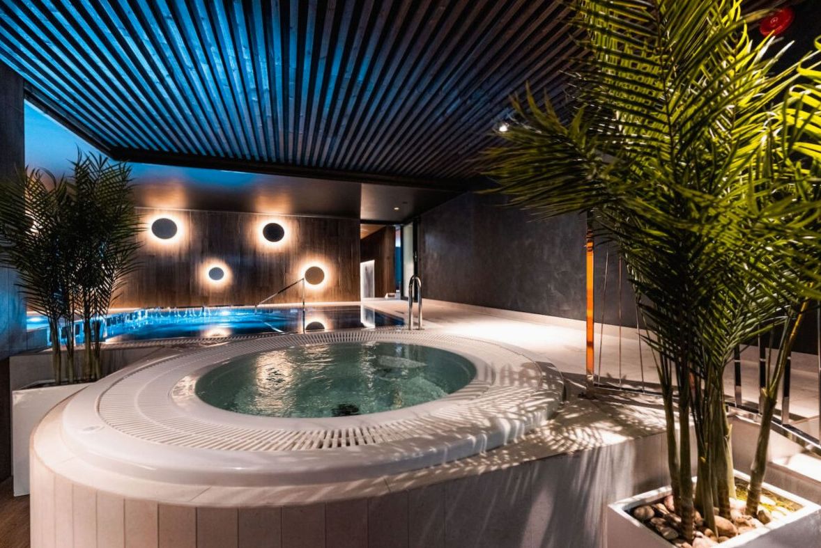 Serene spa treatment room with stone features, warm lighting and native New Zealand botanicals